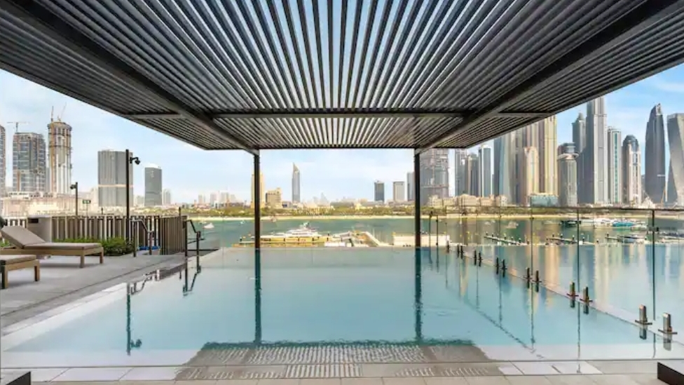 Shaded pool with marina and skyline views