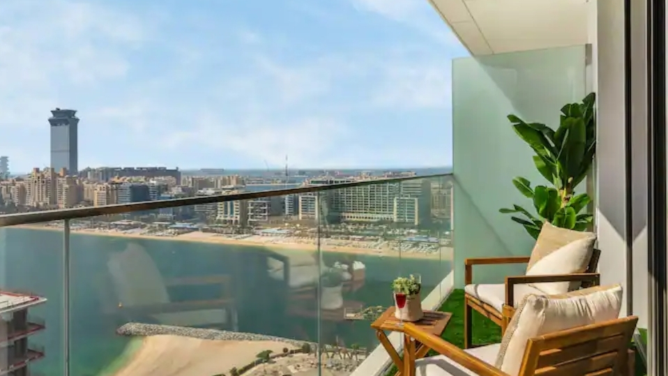 Balcony with sea and beach views by day